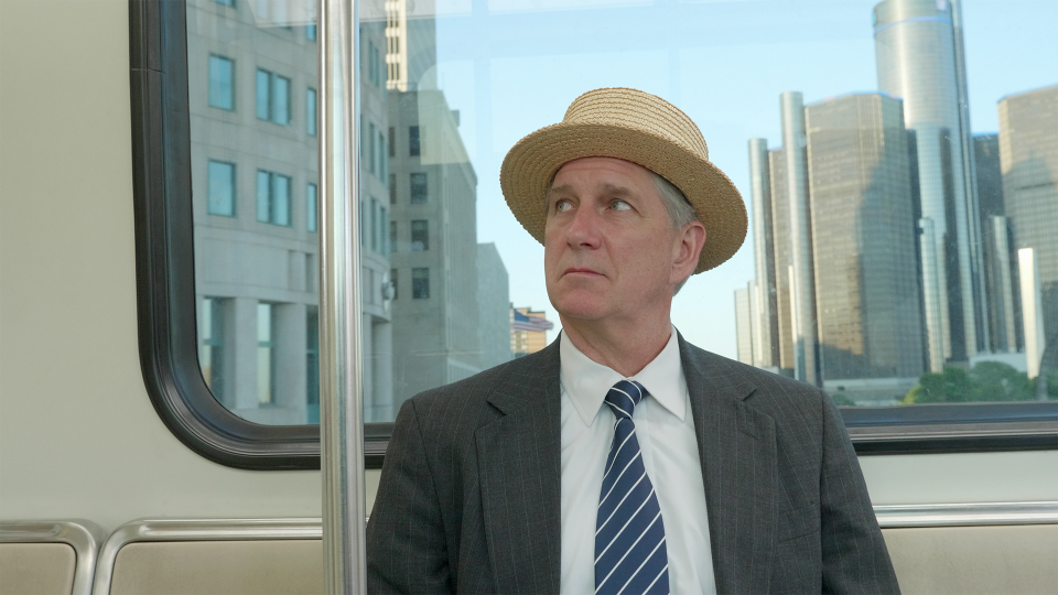 The ghost of Henry Ford (John Lepard) kills time on Detroit’s People Mover in a scene from "10 Questions for  Henry Ford."