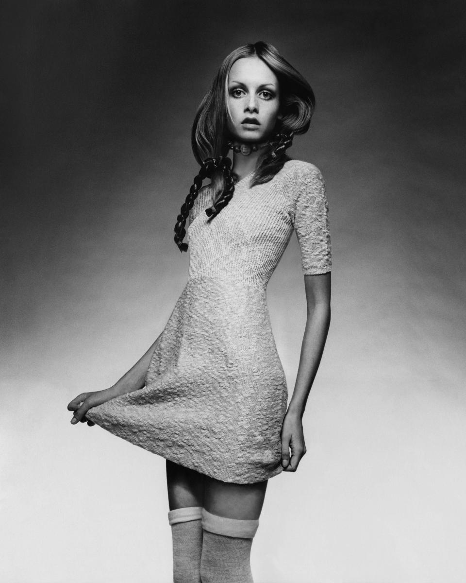 Twiggy wears a knit baby-doll dress with a ribbed bodice by Juliano Knits with thigh-high socks, a choker by Mary Smith and braids by Edith Imre.