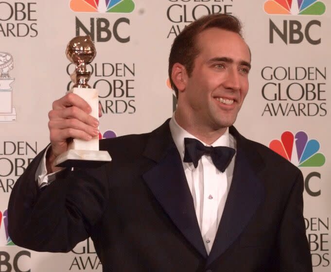 Nicolas Cage lifts the award for best actor in motion picture, drama, for his role in "Leaving Las Vegas" at the Golden Globe Awards, Sunday, Jan. 21, 1996, in Beverly Hills, Calif. (AP Photo/Mark J. Terrill)