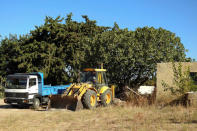 A bulldozer excavates the area under a tree during an investigation for Ben Needham, a 21-month-old British toddler who went missing in 1991, on the island of Kos, Greece, September 28, 2016. REUTERS/Vassilis Triandafyllou