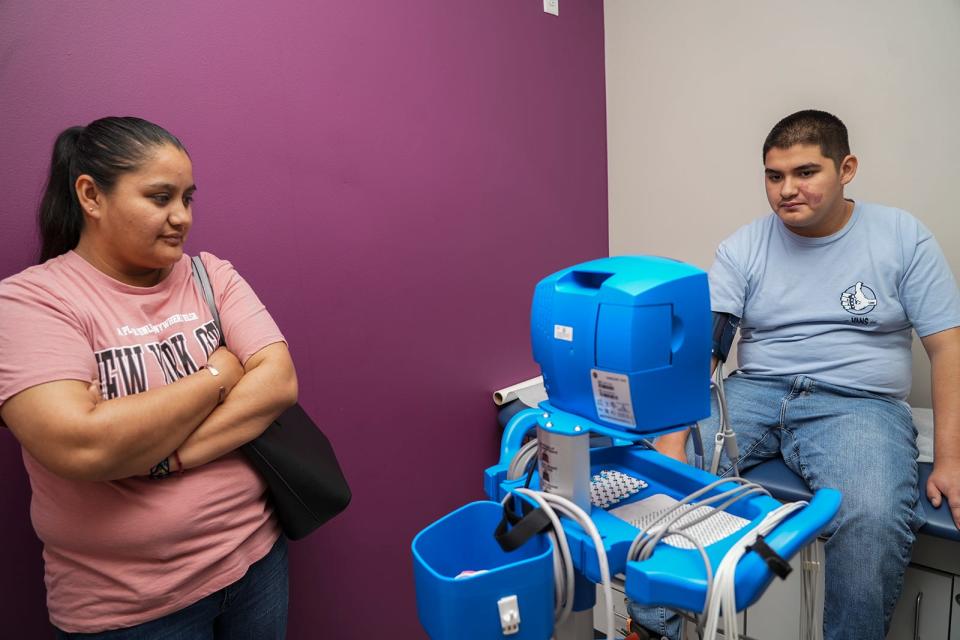 Juan Amador, 13, gets his vital signs taken as his mother, Laura Rojas, accompanies him on his visit to Dell Children's last month. Stroke in children like Juan "is far more common than people think," Dr. Steve Roach said.