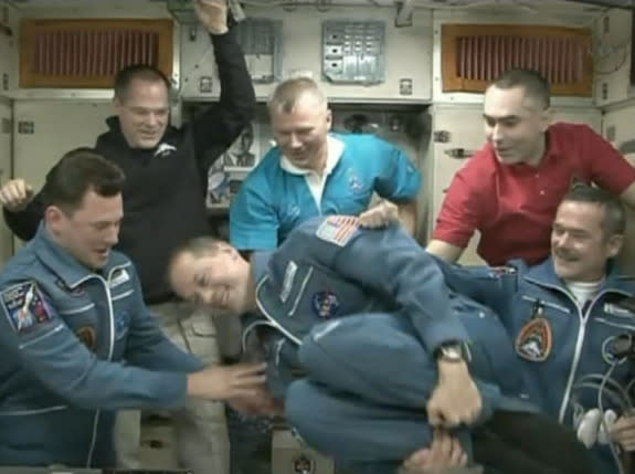 NASA astronaut Tom Marshburn does a flip in zero-g after arriving at the International Space Station Dec. 21. He, Russian cosmonaut Roman Romanenko, and Canadian astronaut Chris Hadfield had just docked aboard a Russian Soyuz spacecraft to join