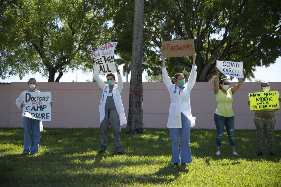 Protesters stand outside ICE's Broward Transitional Center in Pompano Beach, Fla.