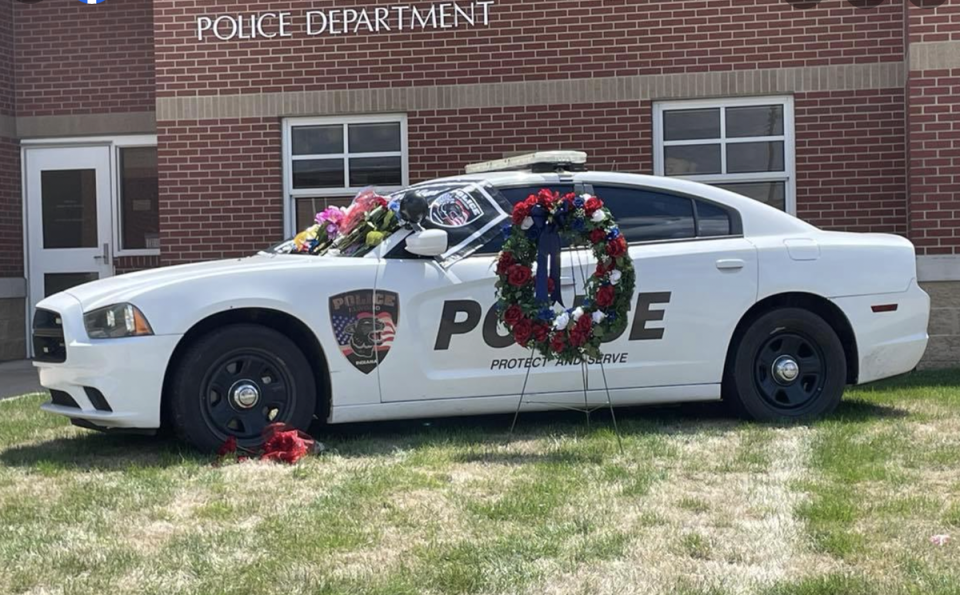 Outside the Elwood Police Department precinct, Officer Shahnavaz’s patrol has been turned into a memorial where members of the communities have left flowers and American flags (Elmwood Police Department)