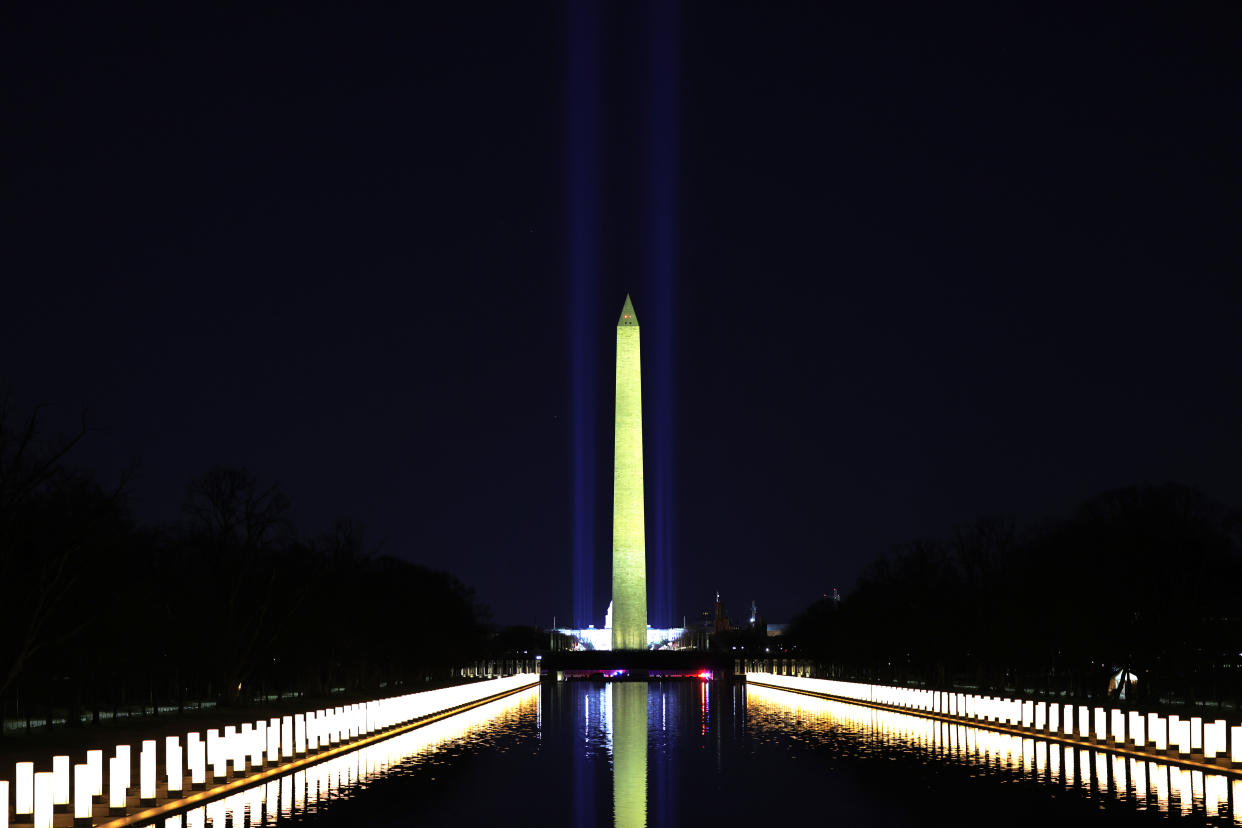 Columns representing victims of the coronavirus line the Lincoln Memorial Reflecting Pool on the eve of Joe Biden's inauguration, Jan. 19, 2021. 