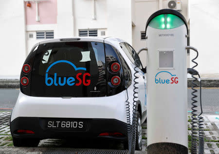 A BlueSG electric car-sharing vehicle is parked at a charging station in a public housing estate in Singapore December 12, 2017. REUTERS/Edgar Su