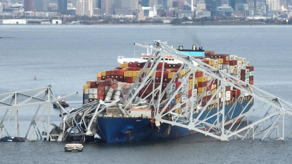 PHOTO: In this aerial image, the steel frame of the Francis Scott Key Bridge sits on top of a container ship after the bridge collapsed, Baltimore, March 26, 2024 (Jim Watson/AFP via Getty Images)