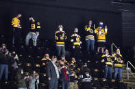 Fans cheer during the second period of an NHL hockey game between the Boston Bruins and the New York Islanders at TD Garden, Monday, May 10, 2021, in Boston. Massachusetts has moved to the next step in its COVID-19 reopening plan, allowing large indoor and outdoor venues, including TD Garden, Fenway Park and Gillette Stadium to increase fan capacity from 12% to 25%. (AP Photo/Elise Amendola)
