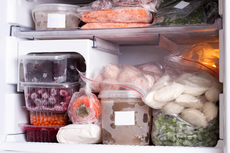 Assortment of frozen vegetables, meat and dumplings in home fridge