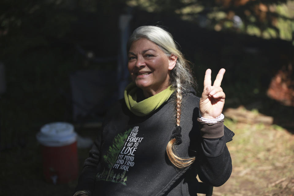 Gina "Mama G" Prince, of Florida, poses for a photo on Friday, July 2, 2021, in the Carson National Forest, outside of Taos, N.M. Prince said she was counting the days when she could return to the Rainbow Gathering, and annual July 4th celebration held in a different state each year. (AP Photo/Cedar Attanasio)