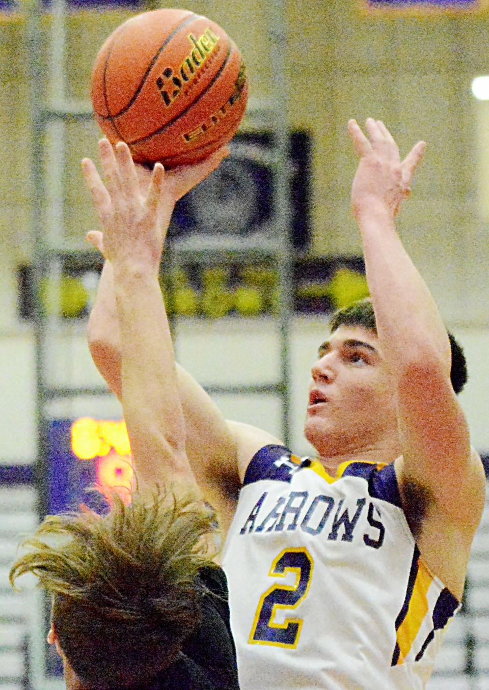 Watertown's Cole Holden puts a up a shot against Huron's Roger Puterbaugh during their Eastern South Dakota Conference boys basketball game Tuesday night in the Civic Arena. Watertown won 59-44.