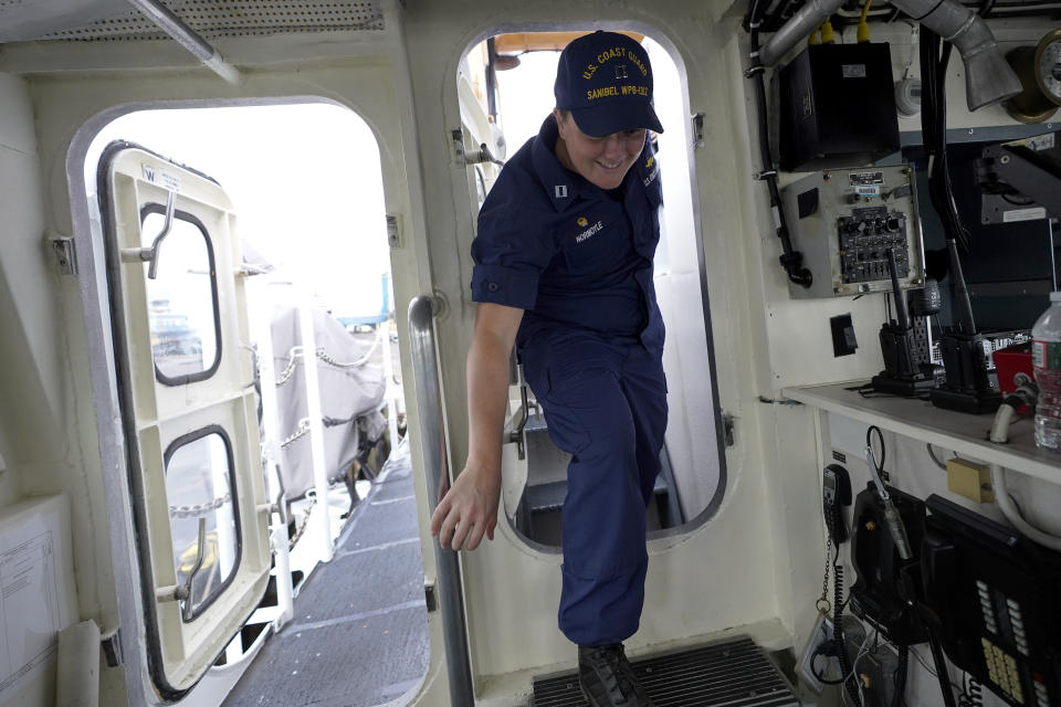 U.S. Coast Guard Lt. Kelli Normoyle, Commanding Officer of the Coast Guard Cutter Sanibel, enters the bridge of the vessel, Thursday, Sept. 16, 2021, at a shipyard in North Kingstown, R.I. Normoyle was one of two cadets who formally started the process to create the CGA Spectrum Diversity Council just a few months after the law known as "don't ask, don't tell" was repealed on Sept. 20, 2011. (AP Photo/Steven Senne)