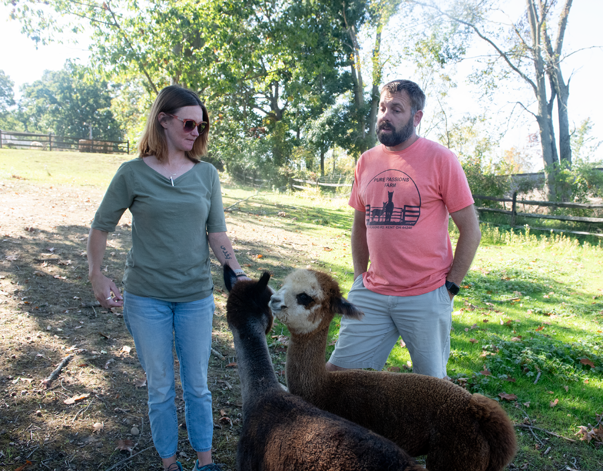 Scott and Sigga Westberg, the owners of Pure Passions Farm, with two baby alpacas, Cotton Candy and Adora, in Franklin Township.