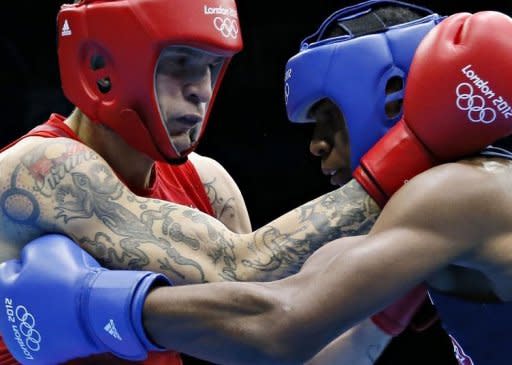 Marcus Browne (R) of the USA and Damien Hooper (L) of Australia mix it up during their first round Light-heavyweight (81kg) match of the London 2012 Olympic Games at the Excel Arena in London. Hooper was awarded a 13-11 points decision