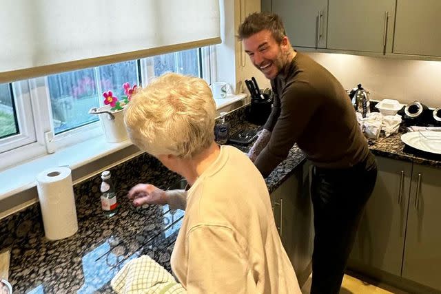 <p>David Beckham/Instagram</p> David Beckham and his mom Sandra laugh as they clean up after having lunch together