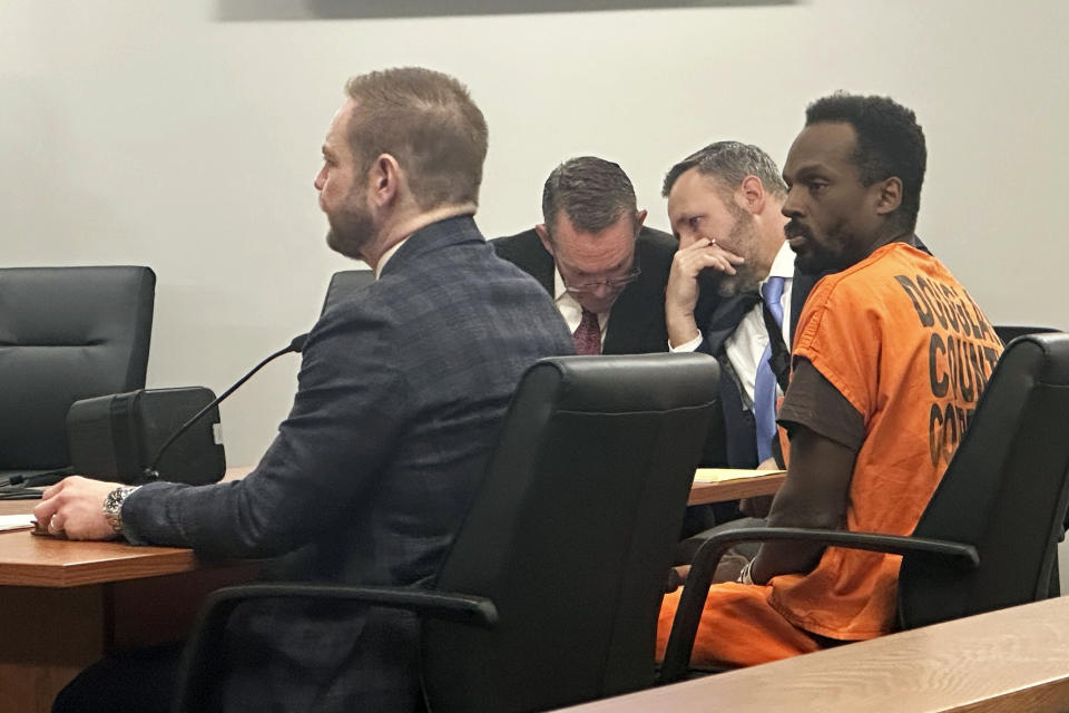 Kierre Williams, right, sits with his attorneys in court Wednesday morning, Jan. 3, 2024, in Blair, Neb. Williams is charged with fatally stabbing a small-town priest during a Dec. 10, 2023, break in at the home where the priest lived next to his church in Fort Calhoun, Neb. (AP Photo/Josh Funk)