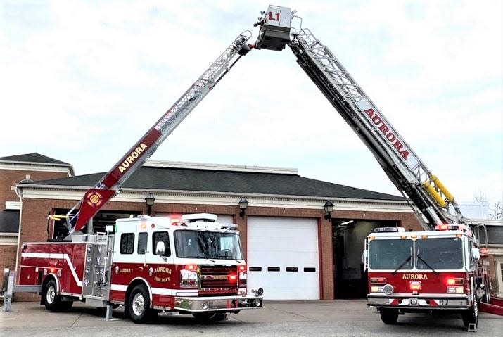 The Aurora Fire Department’s new 2022 Rosenbauer aerial ladder truck and its former 1986 Emergency One ladder truck are parked outside Station 1.