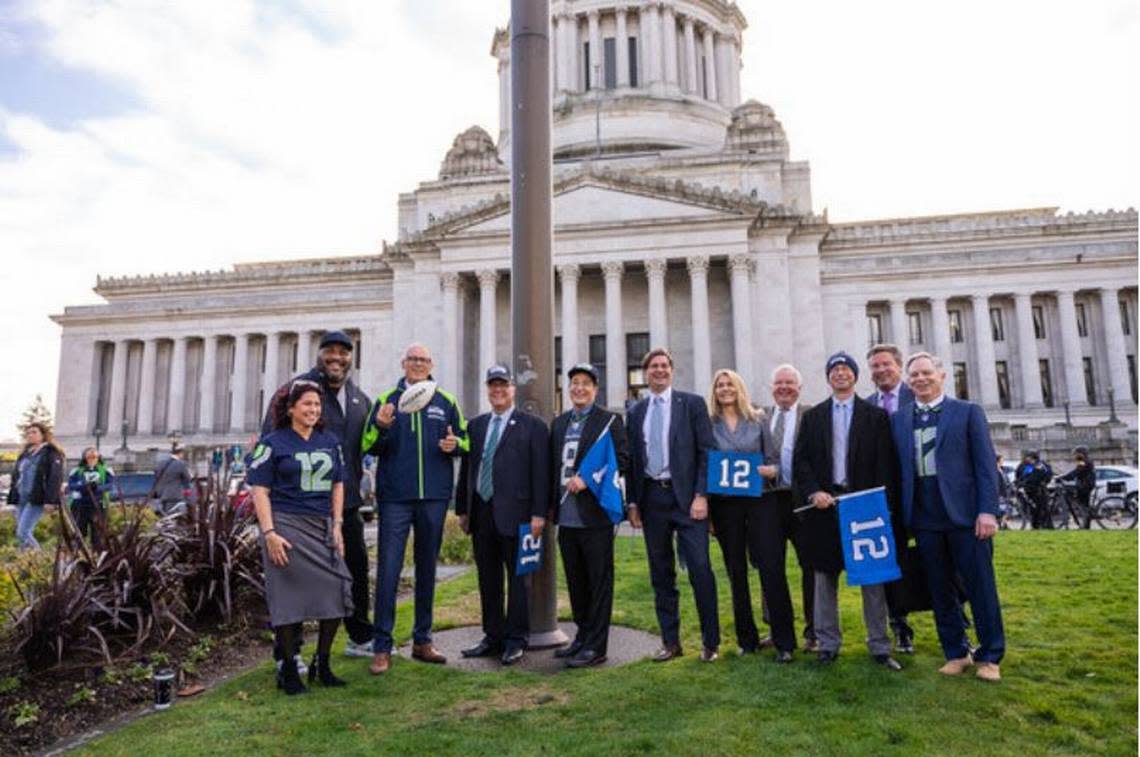 Seahawks Hall of Famer Walter Jones (second from left) joined Gov. Jay Inslee (third from left), Lt. Gov. Denny Heck, Secretary of State Steve Hobbs, Treasurer Mike Pellicciotti, plus legislators and fans to raise the 12 Flag at the State Capitol in Olympia this week. It will fly there as the Seahawks play in the NFC playoffs Saturday at the San Francisco 49ers in Santa Clara, California.