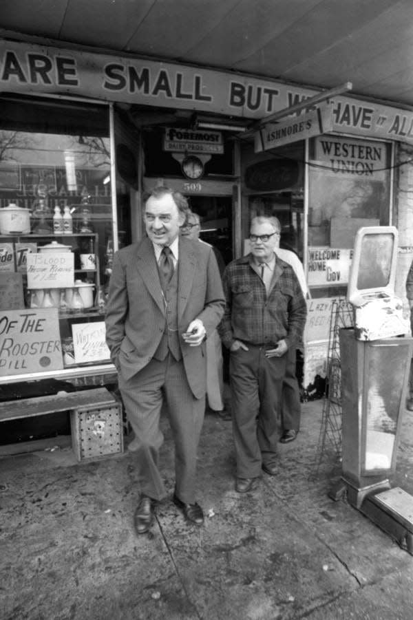 Gov. Claude R. Kirk walking out of Ashmore's, in the Frenchtown section of Tallahassee, Florida. Next to him is owner Rob Roy Ashmore. This photo was taken in 1967.