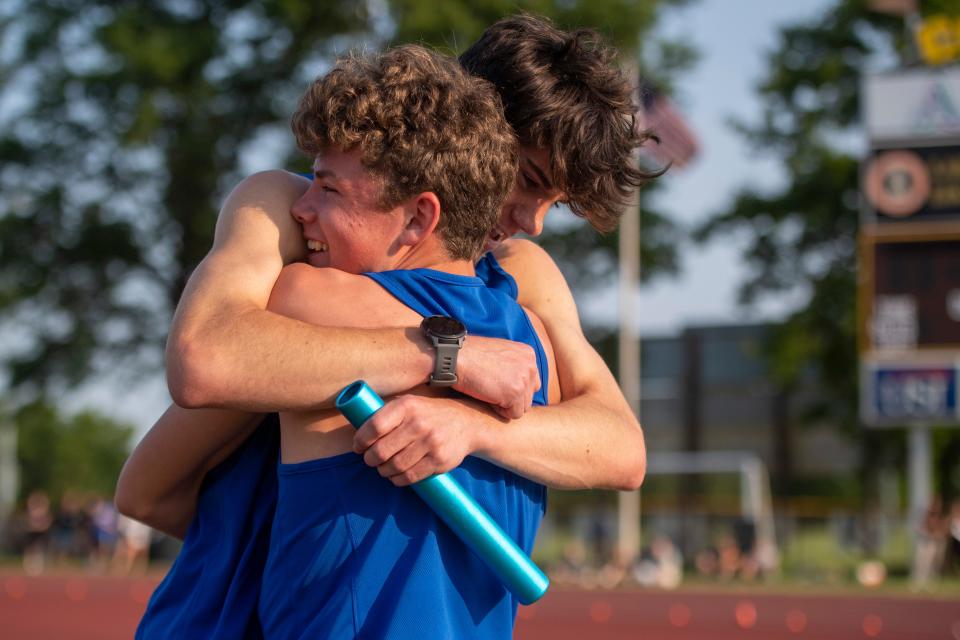 Castle’s Gabe Land hugs Jackson Kramer after finishing first in the 3200 meter relay during the 2023 IHSAA Boys Regional Track and Field meet at Central High School in Evansville, Ind., Thursday, May 25, 2023.