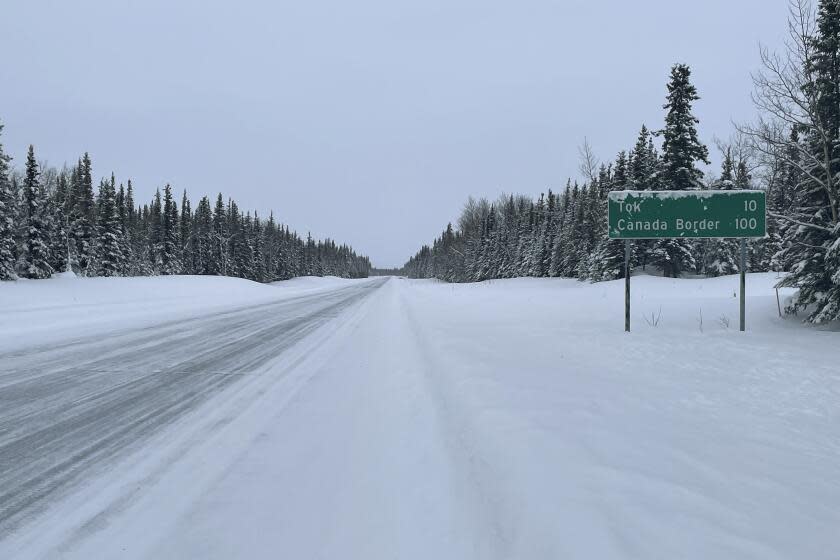 A sign displays the distance to Tok, Alaska, and the Canada border in Glennallen, Alaska on Feb. 1, 2023. Many electric vehicle batteries lose power when it's very cold. It's something that's long been known by engineers but thousands of people are confronting the issue now if they own an electric car and have to make a longer trip when temperatures dip.(AP Photo/Mark Thiessen)