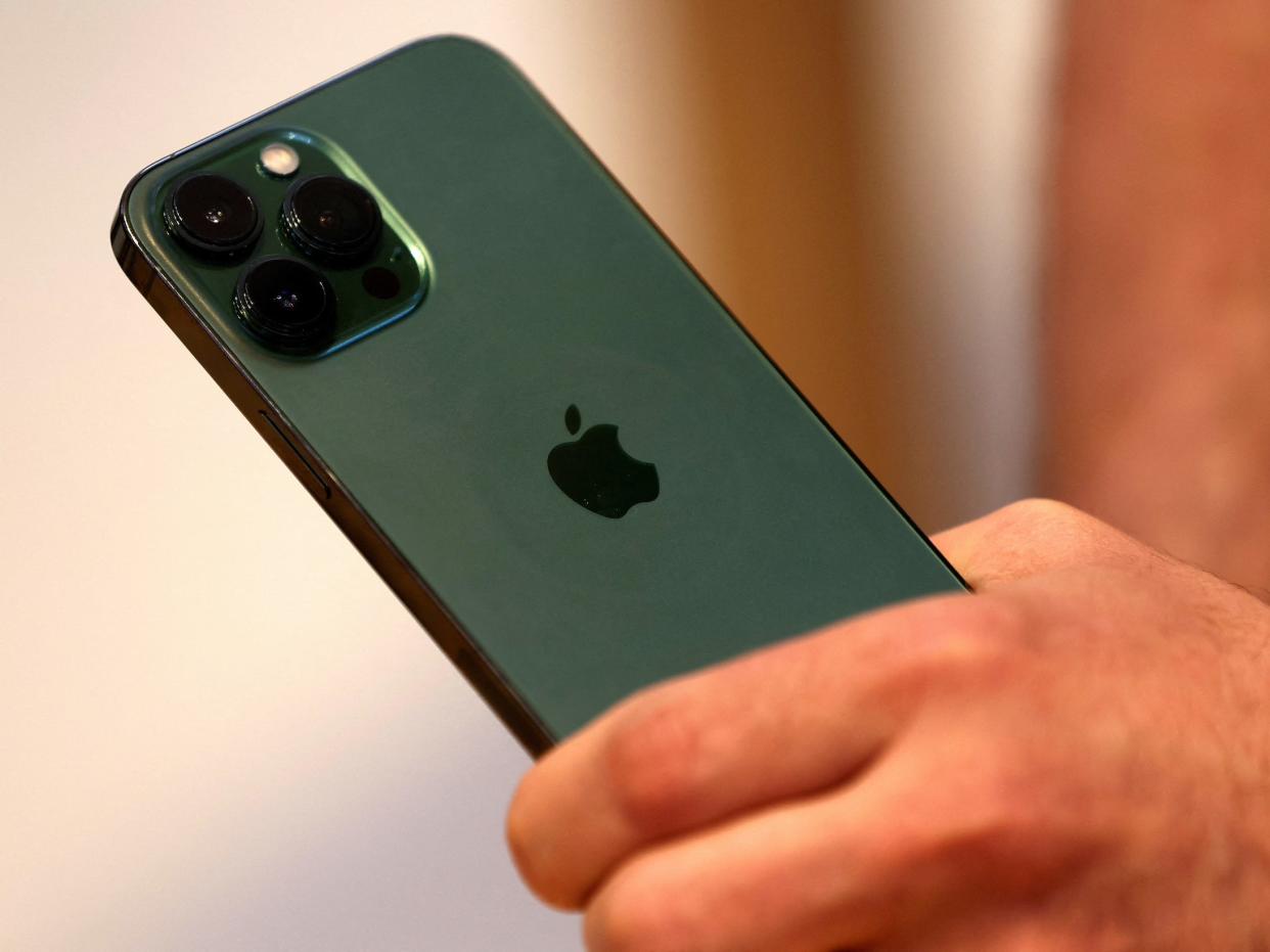 Hand holds Apple's new green iPhone 13 Pro