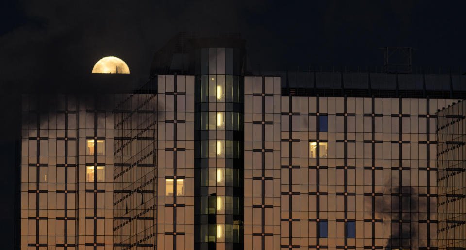 A partial lunar eclipse phase on Jan. 21 over the Paul-Henri Spaak building of the European Parliament in Brussels.