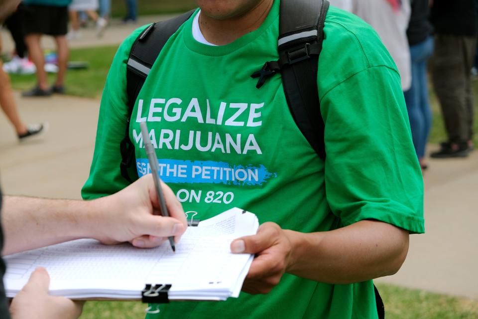 Juan Bermeo collects signatures June 25 for an initiative petition that would appear on the ballot as State Question 820, to legalize recreational marijuana.