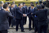 The head of the North Korean delegation Ri Son Gwon, center left, is greedy by an unidentified South Korean official upon his arrival at the South side for the meeting with South Korea at Panmunjom in the Demilitarized Zone, South Korea, Monday, Oct. 15, 2018. The rival Koreas are holding high-level talks Monday to discuss further engagement amid a global diplomatic push to resolve the nuclear standoff with North Korea. (Korea Pool/Yonhap via AP)