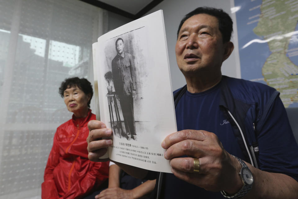 Lee Gwang-nam holding a photo of his father Lee Dol-mong speaks during an interview at a house of Shin Yun-sun, not in photo, in Seoul, South Korea Wednesday, July 29, 2020. The thousands of husbands and fathers who never returned from Sakhalin after eight decades is a largely forgotten legacy of Japan’s brutal rule of the Korean Peninsula before the end of World War II. Lee, 76, and Shin, 75, are among about 400 aging relatives who hope to bring back the remains of the missing workers, seeking closure after years of emotional distress and economic hardship that affected many of the broken families.(AP Photo/Ahn Young-joon)