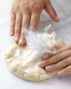 <div class="caption-credit"> Photo by: Martha Stewart Living</div><div class="caption-title">Press the Dough This Way to Form It into a Rough Round</div><b>Press the Dough This Way to Form It into a Rough Round</b> <br> Bring the edges of the plastic wrap together to form a round mass, and press on top of the wrap to form a disk. You're simultaneously gathering the crumbs into a cohesive dough and shaping it.