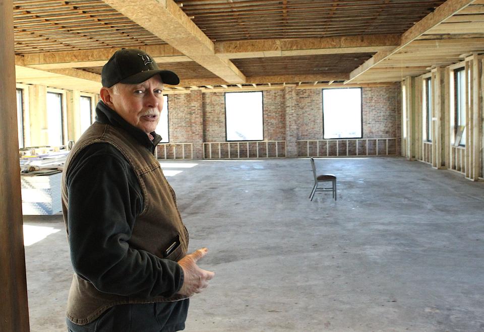CAP Inc. Project Manager Paul Johnson discusses the banquet room in the background. The room will have a large kitchenette, and a bandstand to accommodate wedding receptions and other large gatherings. Johnson estimates the project will be finished "mid-spring." The building was originally the headquarters of Indiana Limestone Co. and is listed on the National Register of Historic Places.