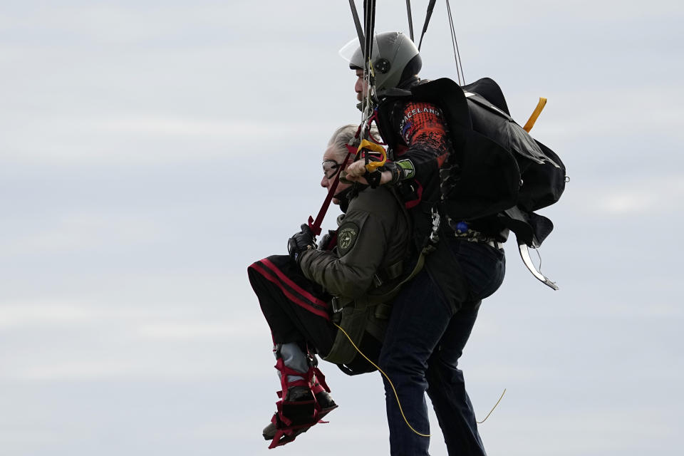 Texas Gov. Greg Abbott skydives in tandem Monday, Nov. 27, 2023, in Fentress, Texas. Abbott was invited to jump by 106-year-old World War II veteran Al Blaschke. (AP Photo/Eric Gay)