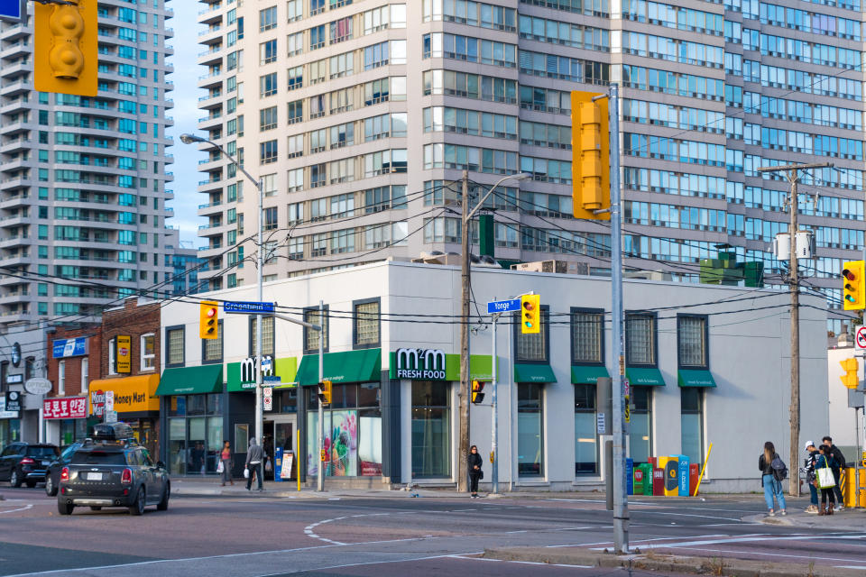 TORONTO, CANADA - 2017/10/22: Yonge Street lifestyles and contrasts. Small family business contrasted against large apartment buildings. The boom in real estate is threatening the disappearance of the vintage small properties. (Photo by Roberto Machado Noa/LightRocket via Getty Images)