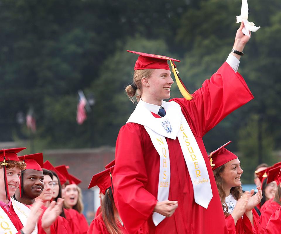 Class treasurer Nicholas Enbar-Salo finds a hidden $100 bill under his seat placed there by Frank Santoro of the school committee. Santoro said at least one person would remember his speech. North Quincy High graduation exercises at Veterans Stadium on Tuesday June 6, 2023