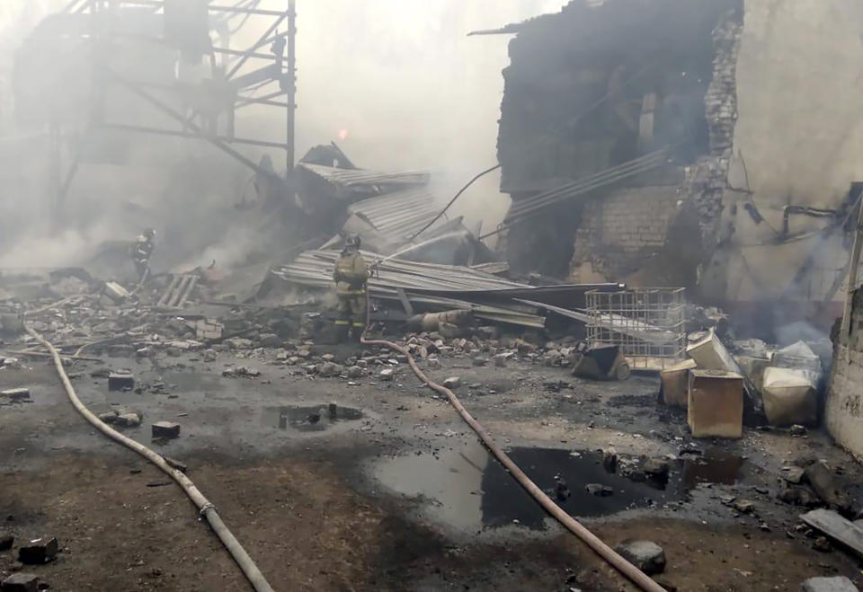 In this photo released by Russian Emergency Ministry Press Service, emergency personnel work at the site of an explosion and fire at a gunpowder factory in the Ryazan region, about 270 kilometers (about 167 miles) southeast of Moscow, Russia, Friday, Oct. 22, 2021. Russian emergency officials say that at least seven people have died and a further nine are missing following an explosion and fire at a gunpowder factory. (Ministry of Emergency Situations press service via AP)