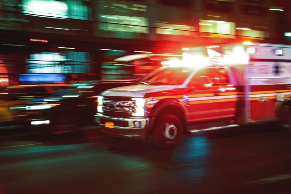 An ambulance speeding down the street.  