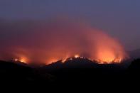 Seen in a long exposure photograph, the Soberanes Fire burns along ridges above Carmel-By-The-Sea, California, U.S. July 27, 2016. REUTERS/Noah Berger