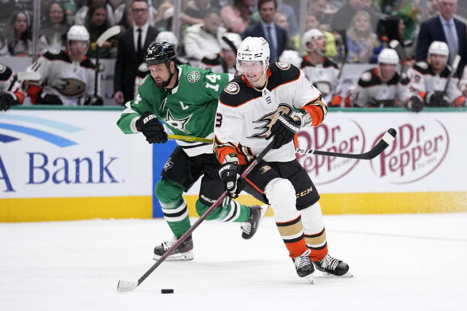 Anaheim Ducks defenseman John Klingberg (3) controls the puck as Dallas Stars left wing Jamie Benn (14) follows in the second period of an NHL hockey game, Monday, Feb. 6, 2023, in Dallas. (AP Photo/Tony Gutierrez)