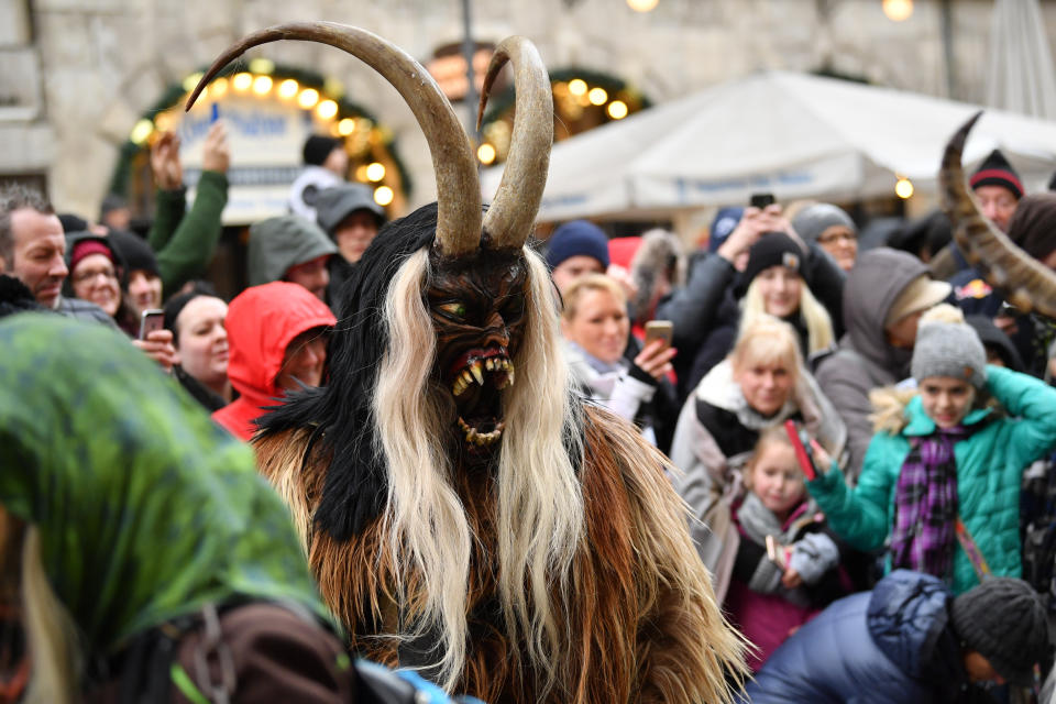 MUNICH, GERMANY - DECEMBER 09: Actors dressed as the Krampus creature parade through the city center's pedestrian shopping district on December 9, 2018 in Munich, Germany. Krampus traditionally accompanies Saint Nicholas and angels in a house to house procession to reward children who have been good and warn those who have not, though in recent decades Krampus parades have become an intrinsic part of local folklore and take place throughout the end of November and into the first half of December in the alpine regions of Germany, Austria and Italy. Krampus usually wears large cowbells on his back that he rings by shaking his hips to ward off the evil spirits of winter. He also carries a switch made of branches or animal hair that he uses to whip bystanders. (Photo by Sebastian Widmann/Getty Images)