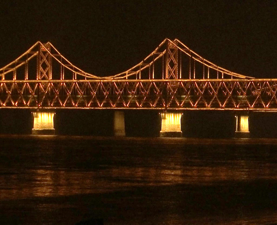 In this image taken from video footage, a train similar to ones seen during previous visits to China by North Korean leader Kim Jong Un crosses the Friendship Bridge from North Korea into China as seen from Dandong in northeastern China's Liaoning Province, Saturday, Feb. 23, 2019. A train similar to one used in the past by Kim Jong Un entered China on Saturday evening, possibly carrying the North Korean leader on a journey to Vietnam's capital for his summit with President Donald Trump. (AP Photo/Dake Kang)