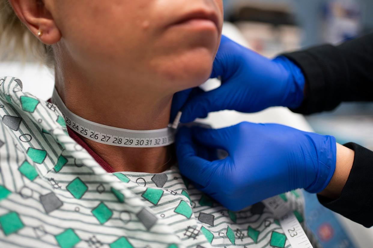 Forensic nurses, Kelly Tomlinson, right, and Jennie Medley, demonstrate how they measure the neck of a strangulation victim at the Mount Carmel Clinical Skills and Simulation Lab in this April 2023 file photo.