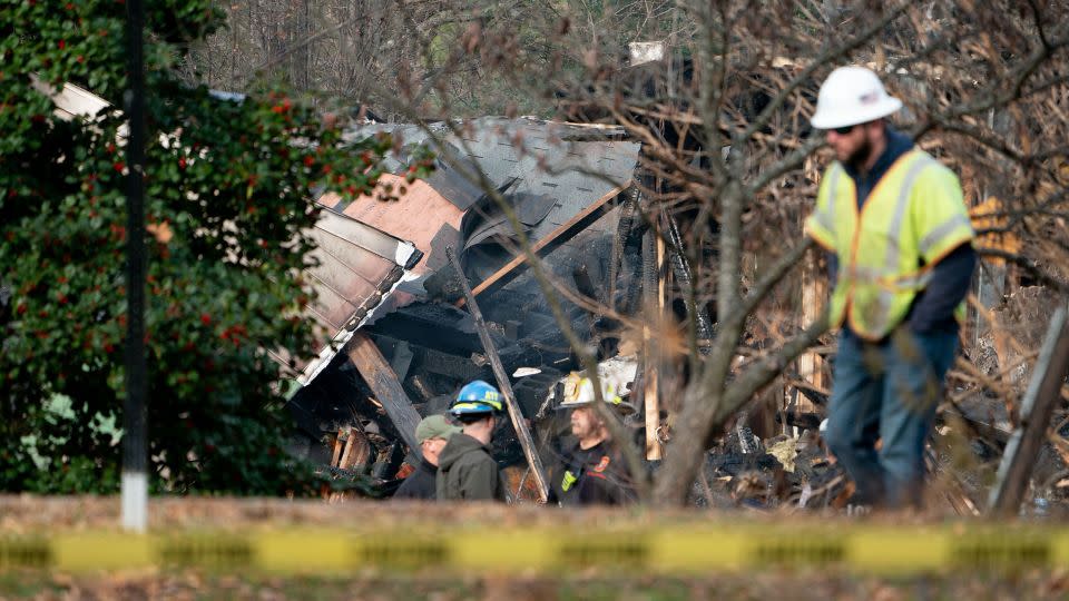 Authorities gather Tuesday at the scene of a home that exploded a day earlier in Arlington, Virginia. - Stefani Reynolds/AFP/Getty Images