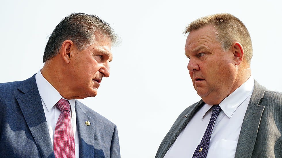 Sen. Joe Manchin (D-W.Va.) speaks with Sen. Jon Tester (D-Mont.) during a press conference on Friday, July 30, 2021 to discuss the bipartisan infrastructure deal with members of the Problem Solvers Caucus.