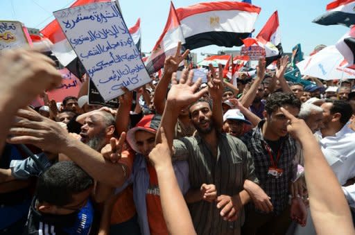 Egyptians wave national flags during a rally in support of president-elect Mohamed Morsi in Cairo's iconic Tahrir Square