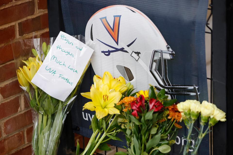 Mourners placed flowers outside Scott Stadium in memory of three Virginia football players who were killed Sunday.