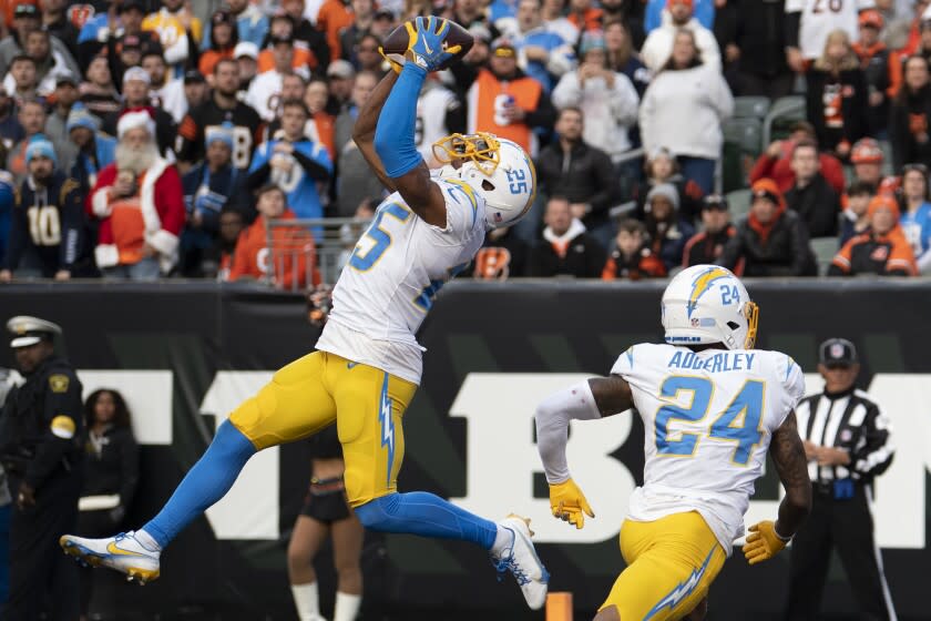 Los Angeles Chargers cornerback Chris Harris Jr. (25) intercepts the ball during the second half of an NFL football game against the Cincinnati Bengals, Sunday, Dec. 5, 2021, in Cincinnati. (AP Photo/Emilee Chinn)