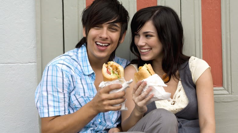 two people eating po'boys
