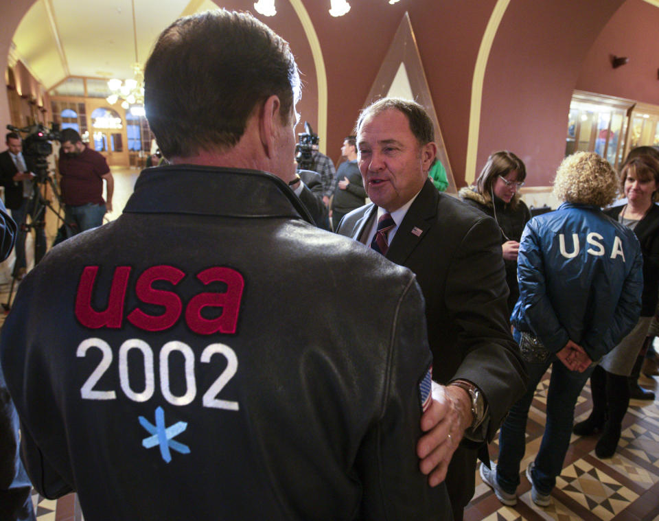 Gov. Gary Herbert, center, talks with Fraser Bullock, chief operating officer of the 2002 Winter Games, after the USOC choose Salt Lake over Denver to bid on behalf of the US for future Winter Games, Friday, Dec. 14, 2018 in Salt Lake City. Salt Lake City got the green light to bid for the Winter Olympics — most likely for 2030 — in an attempt to bring the Games back to the city that hosted in 2002 and provided the backdrop for the U.S. winter team's ascendance into an international powerhouse. (Steve Griffin/The Deseret News via AP)