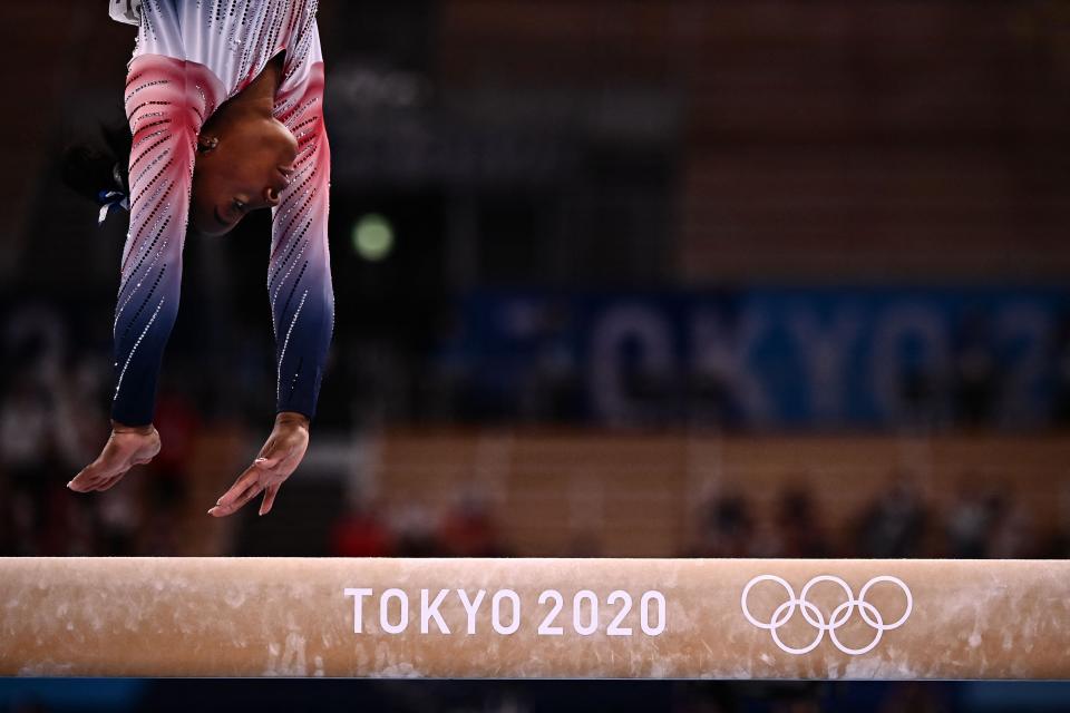 Simone Biles competes in the artistic gymnastics women's balance beam final.